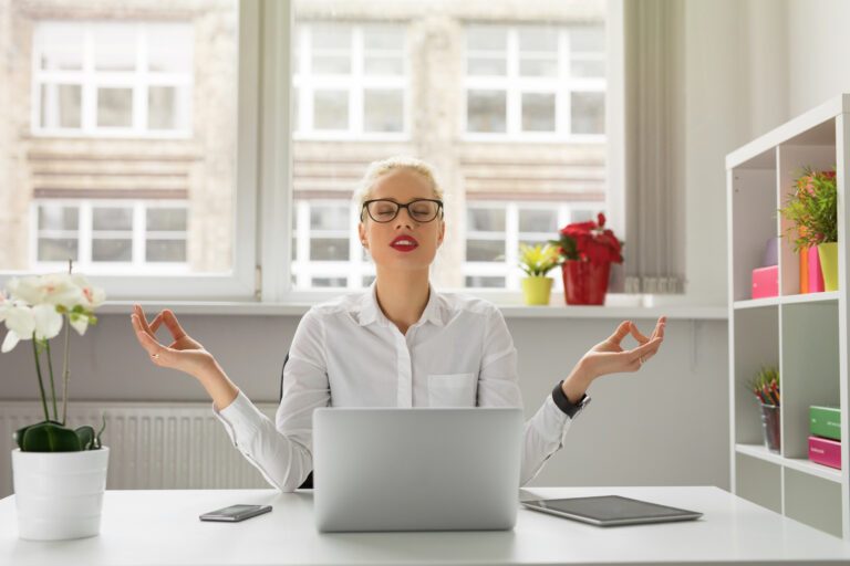 Femme qui se détend devant son ordinateur afin de ne pas stresser